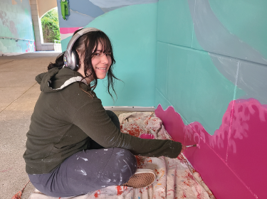 student painting a wall